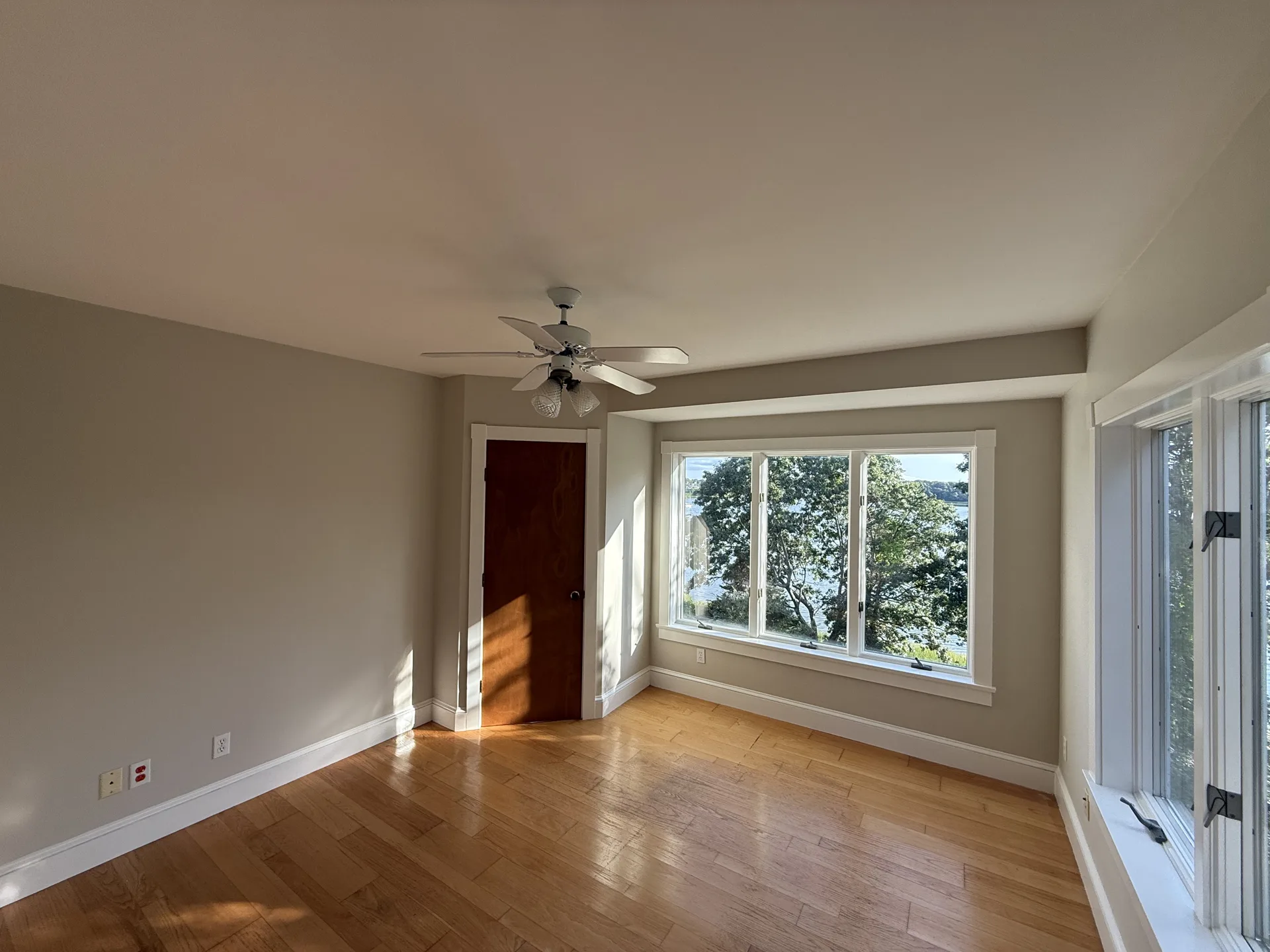 Bright bedroom with large window and fresh interior paint