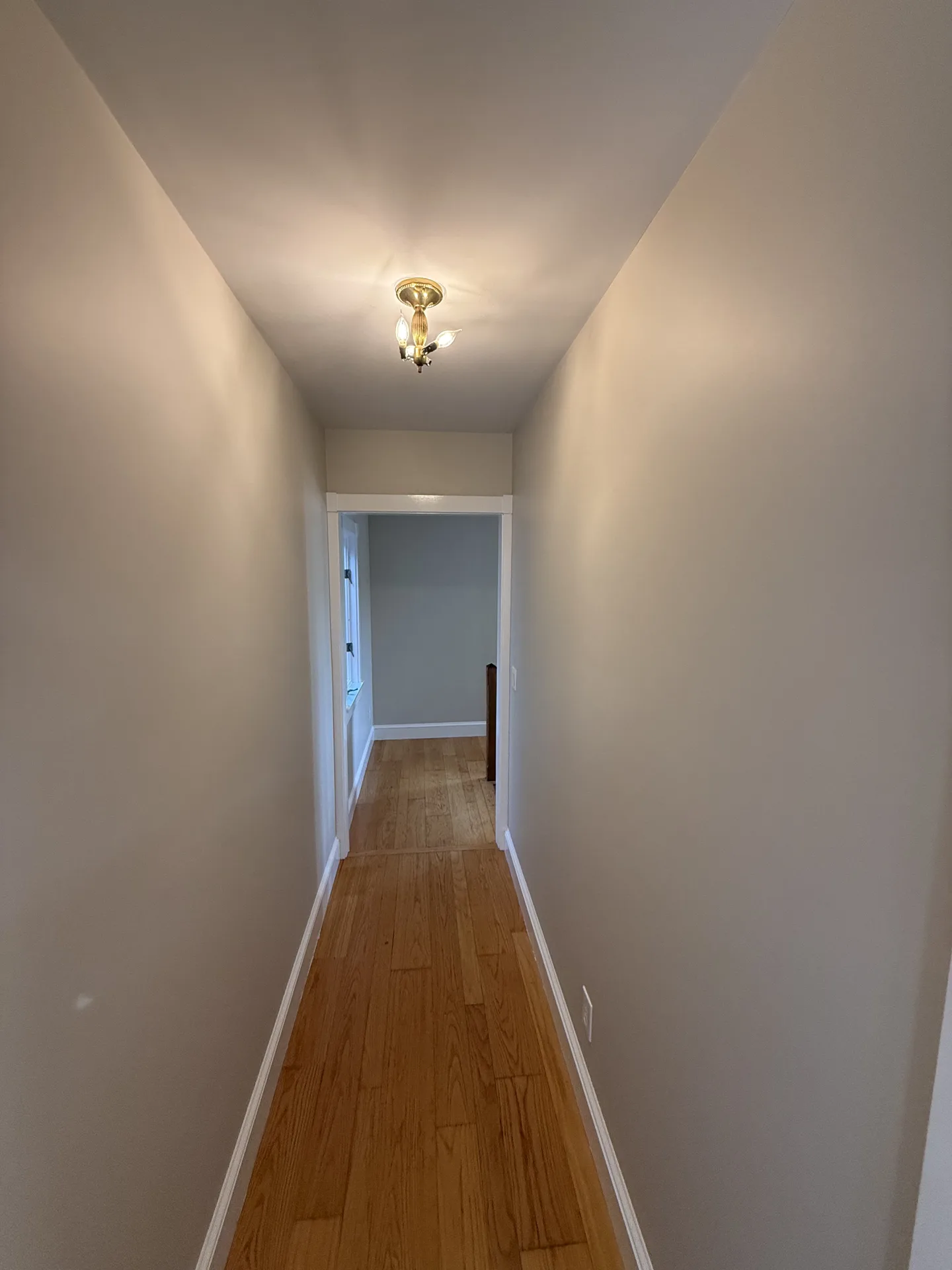 Long hallway with even neutral paint and white trim