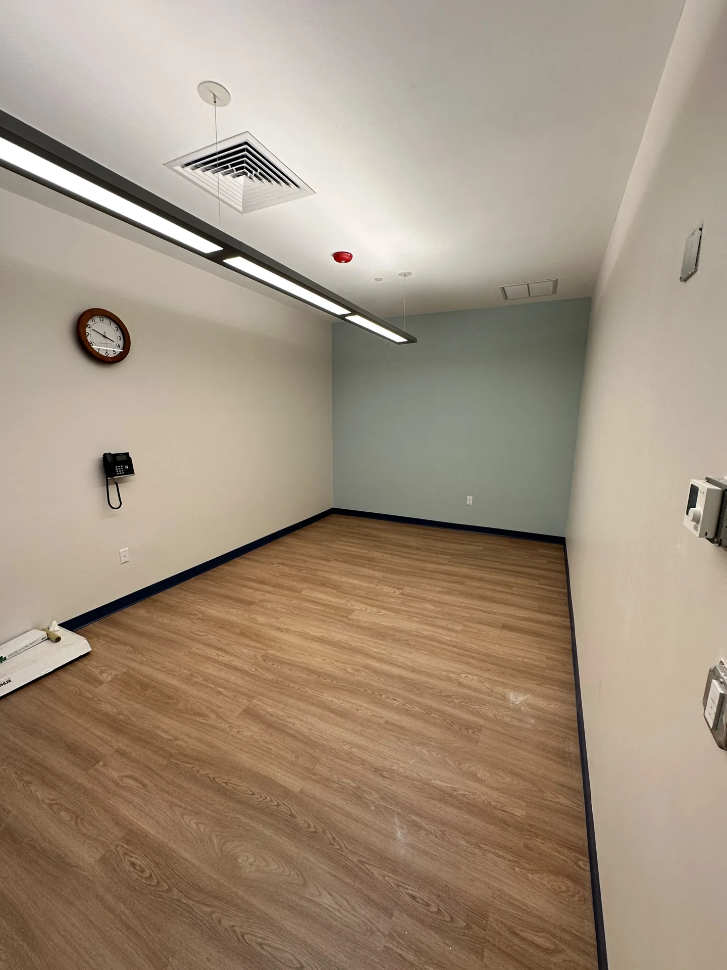 Classroom corner with smooth wall finish and dark baseboards