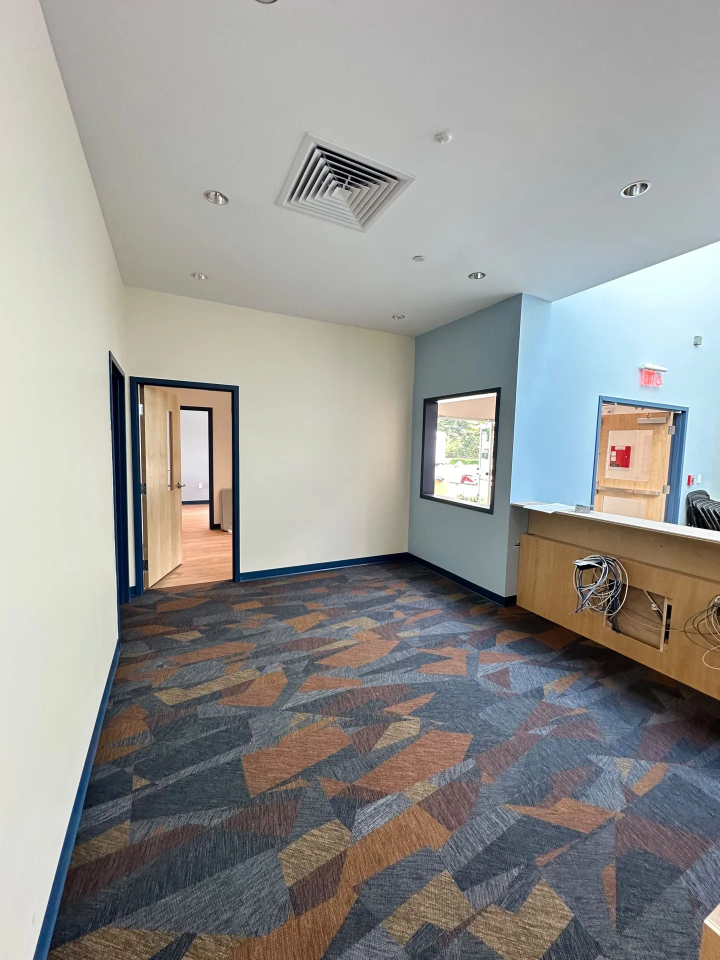 Classroom with painted walls, blue accent wall and interior window
