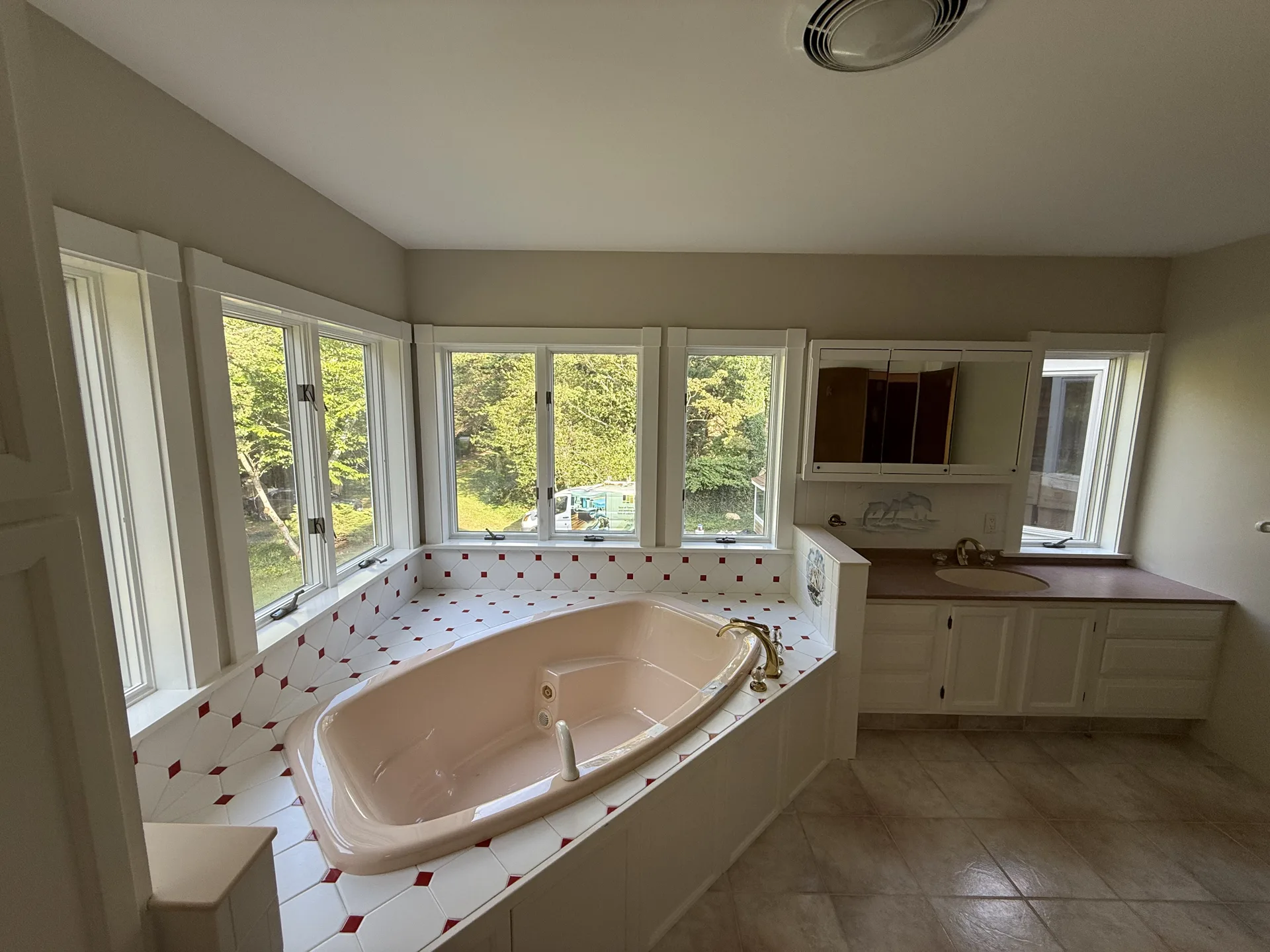 Primary bathroom with corner tub, bright walls and painted trim