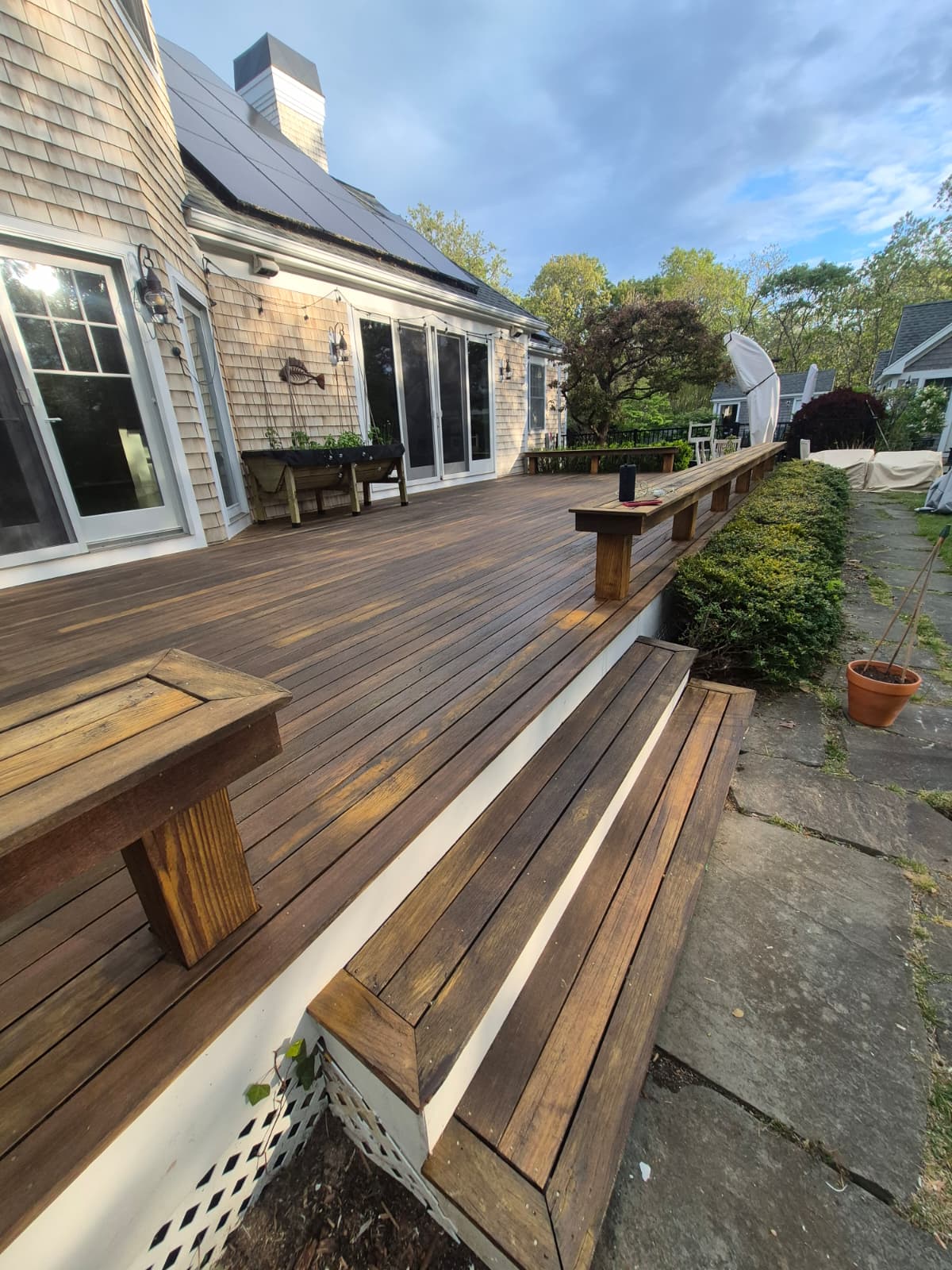 Restored deck with rich brown stained boards and built in benches