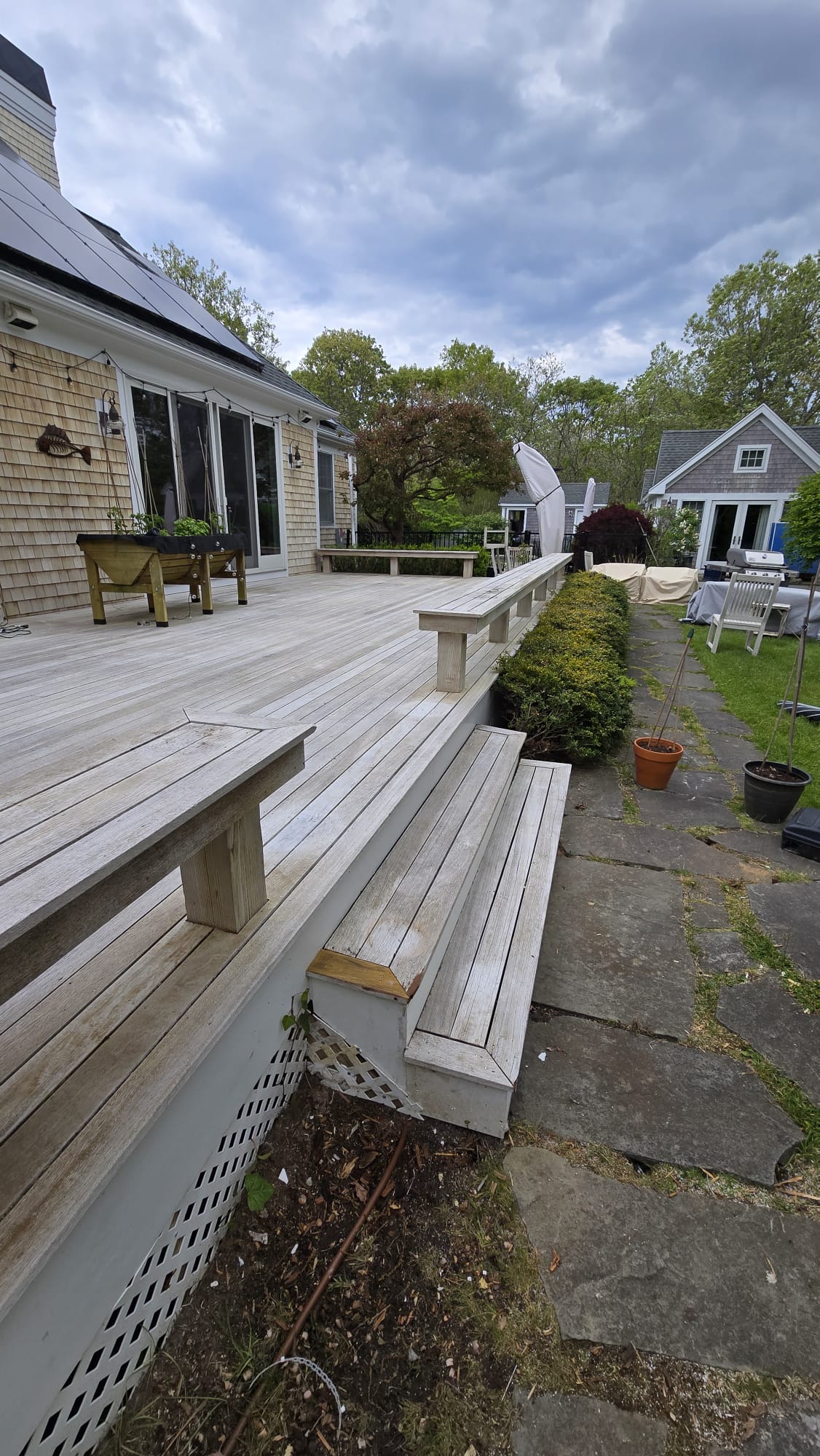 Deck before restoration, weathered gray boards and benches