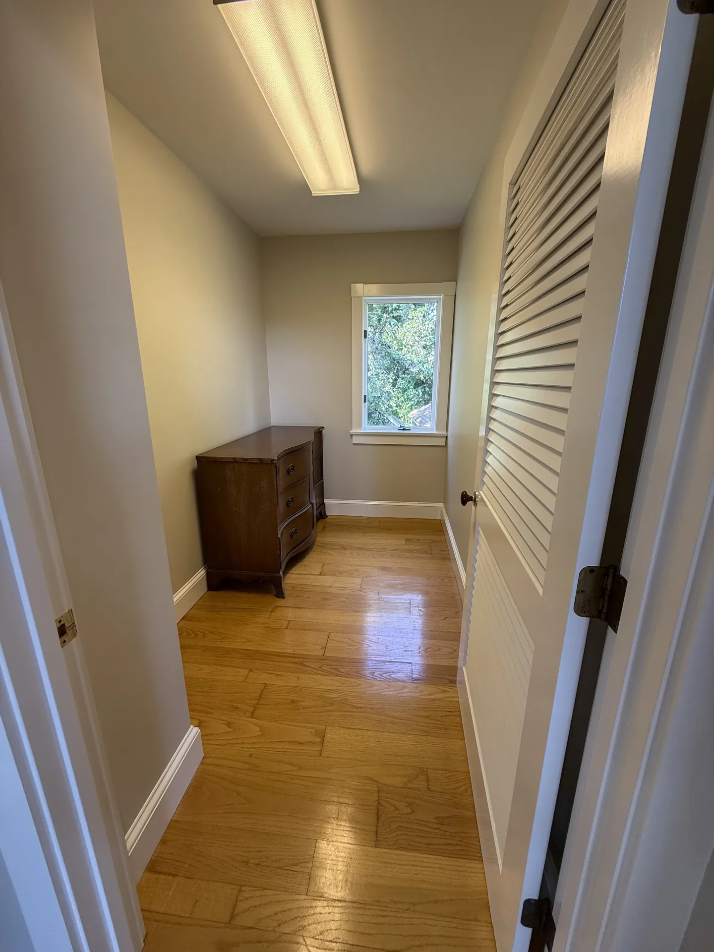 Bedroom entry with painted walls, trim and hardwood floors