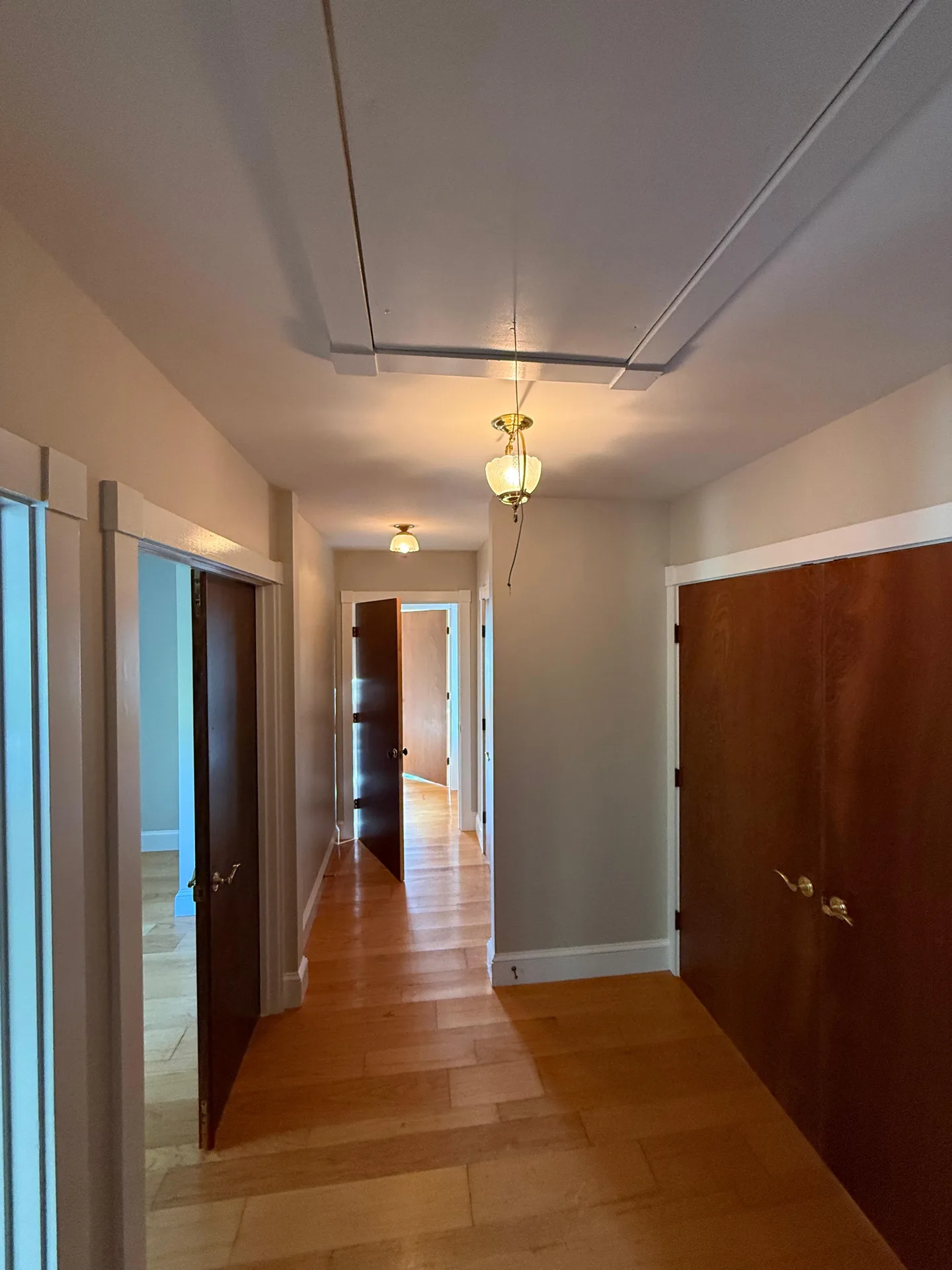 Hallway with crisp white trim and freshly painted neutral walls