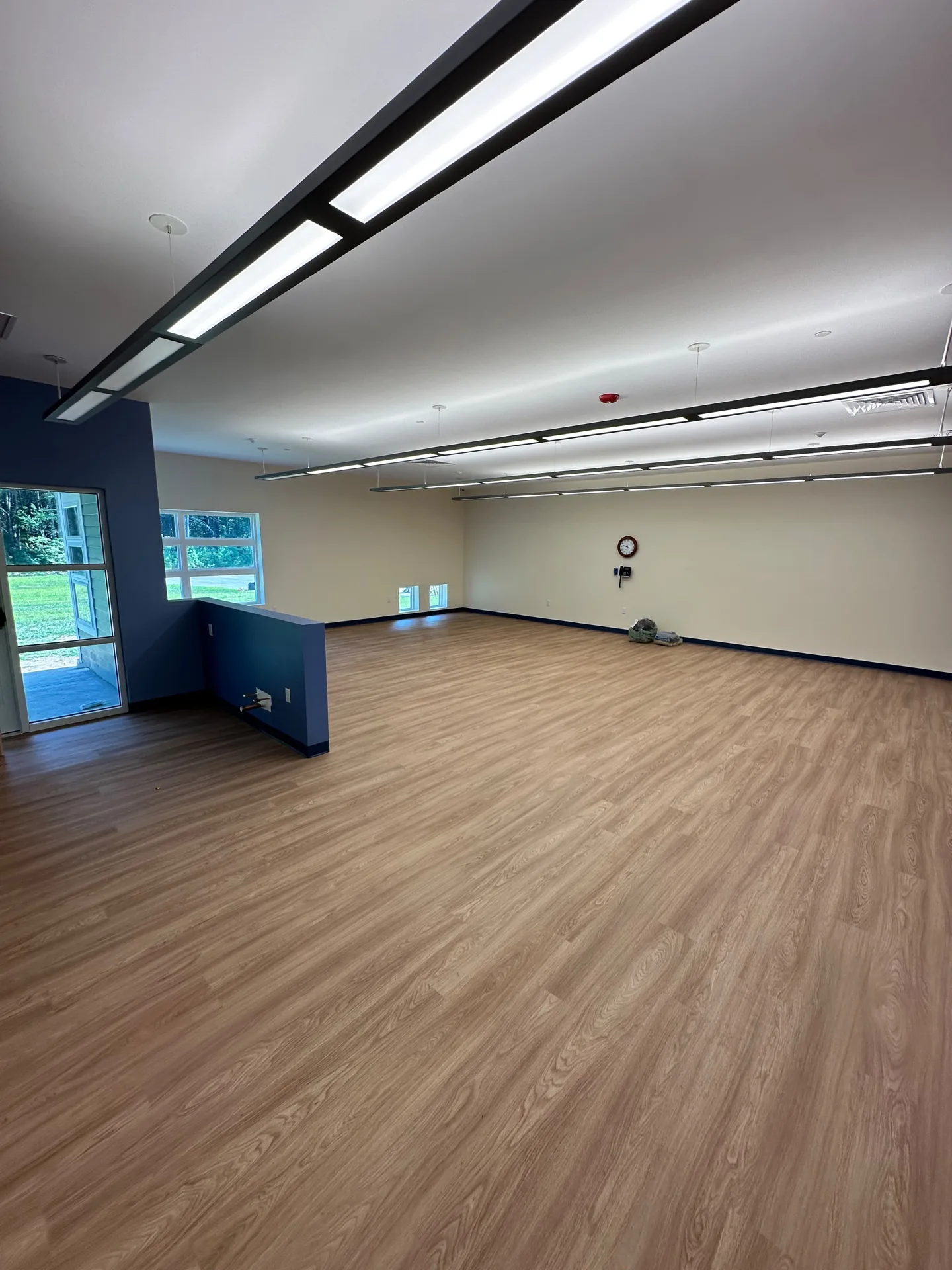 Large classroom with fresh neutral walls and navy blue trim